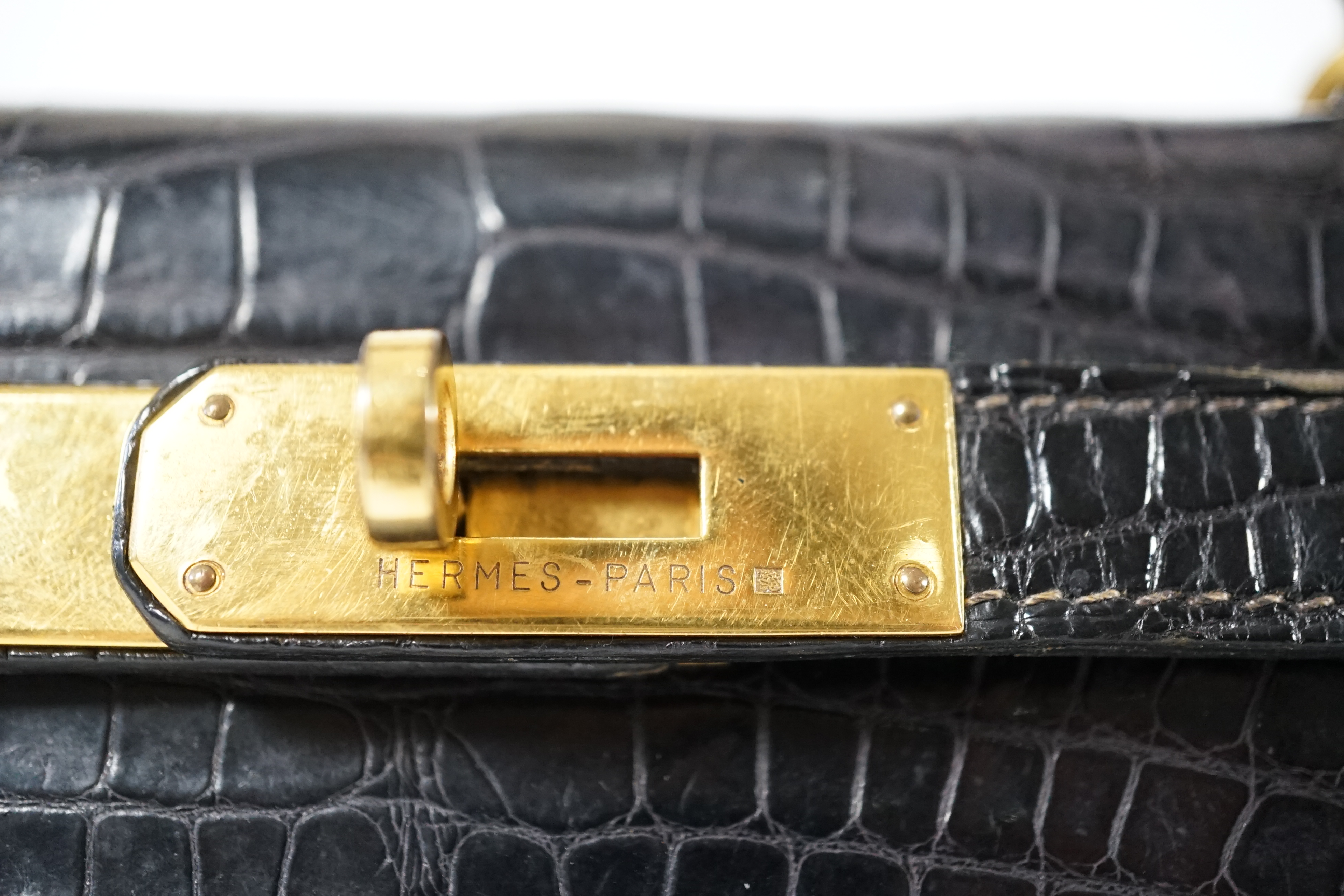 A vintage 1960's Hermès 28 Kelly in black alligator with gilt metalware, height 21cm, top of handle 31cm, width 29cm, depth 12cm